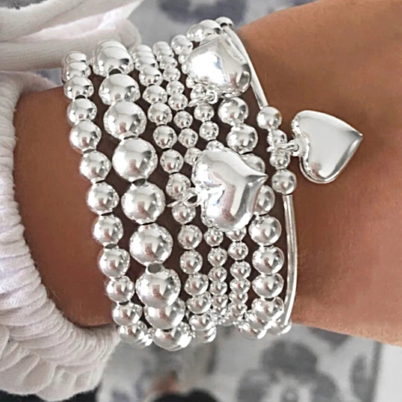 7 PULSERAS BOHOEMIAS CON CORAZÓN DE PLATA